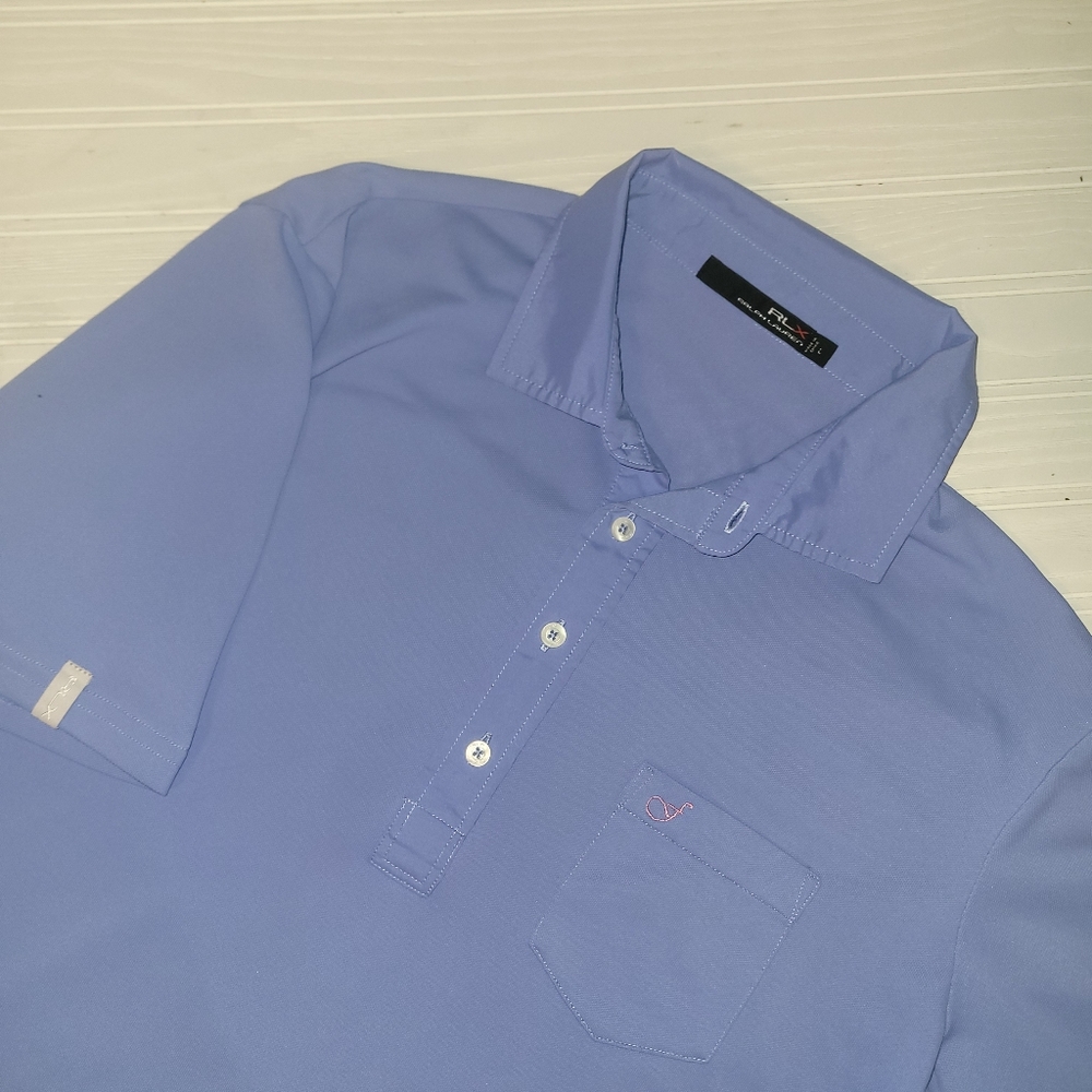 RLX Ralph Lauren Light Blue Golf Golfer Pocket Polo. Has a small pink Logo